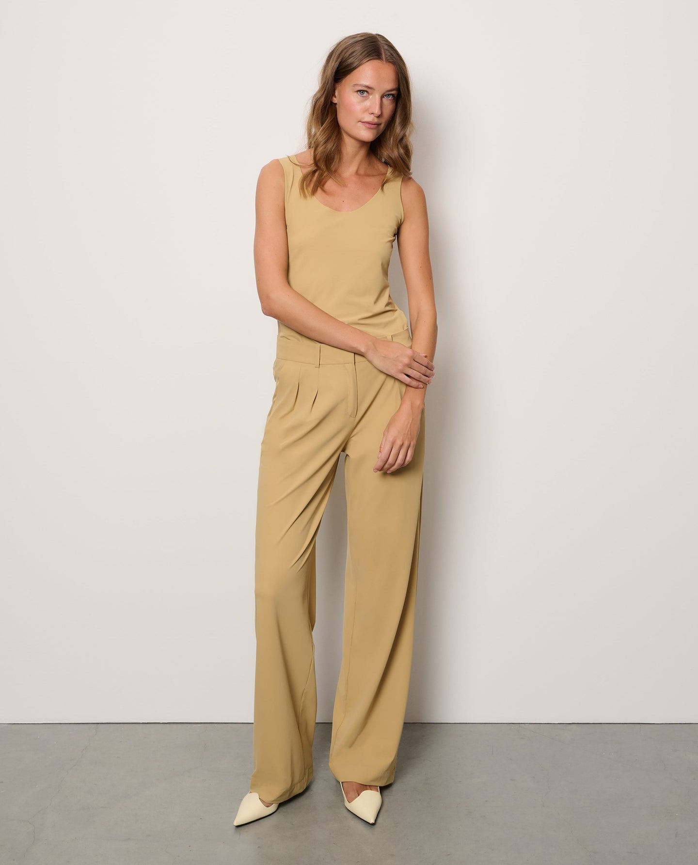 Woman wearing sand top and pants from the Japan TKY Spring Summer 2025 collection